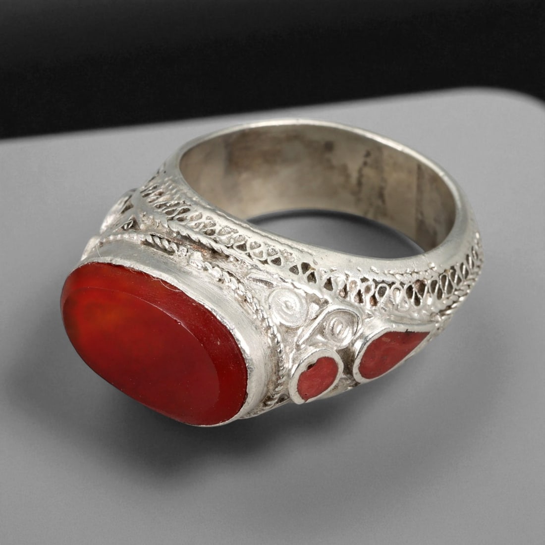 Antique Central Asian Silver Ring with Carnelian Cabochon, c. 19th-20th Century, US 8.5, 38XD: This elegant antique silver ring features a richly colored carnelian cabochon, prized for its warm red-orange glow and symbolic association with vitality, courage, and protection. The stone is set wit