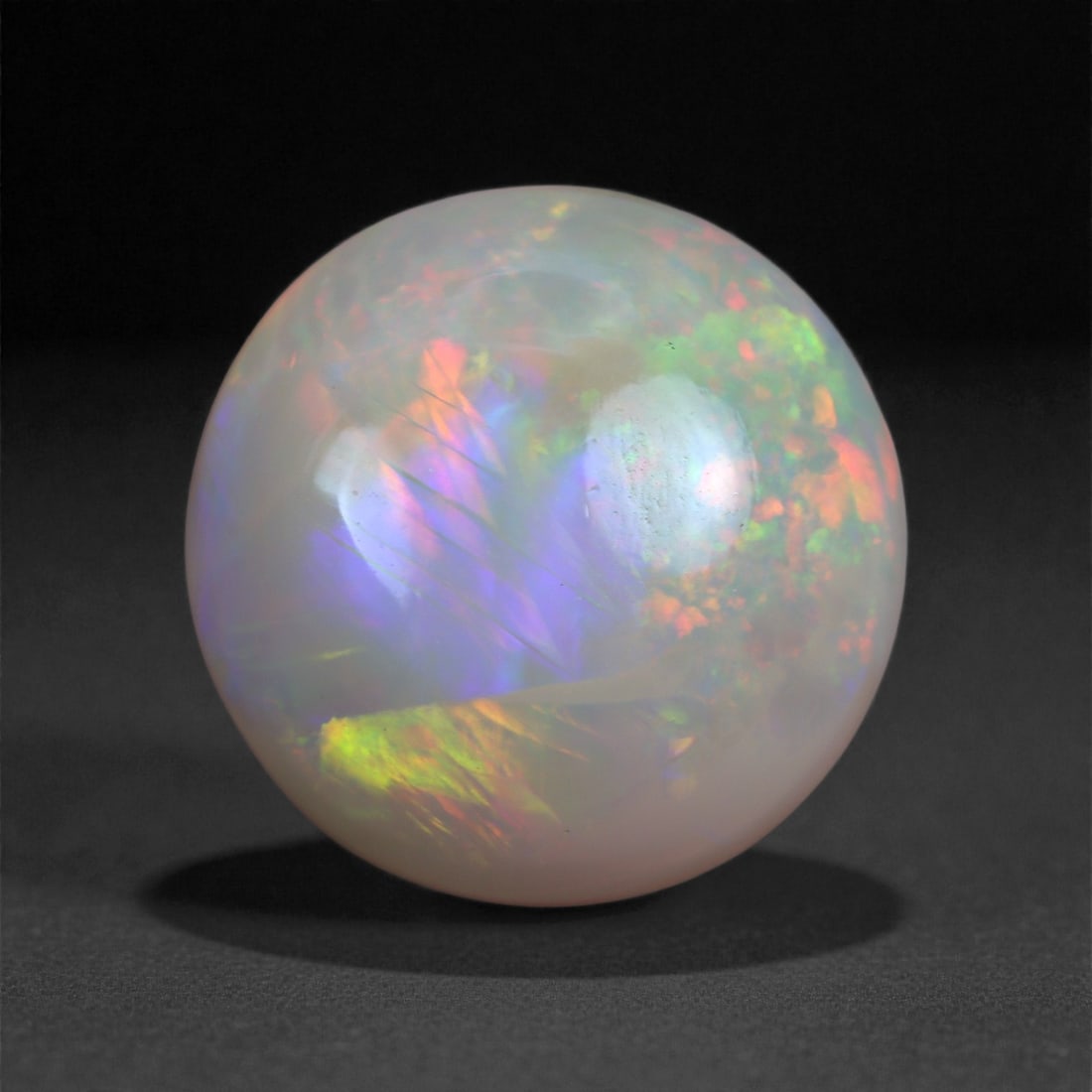 5.58 Carats Play-of-Color Welo Opal - Natural Ethiopian Gem 12x12mm, 31XA: This captivating Welo opal gleams with a luminous cascade of multi neon color that ripple across the stone's surface with every movement. The play-of-color is vivid and well-distributed, presenting a 