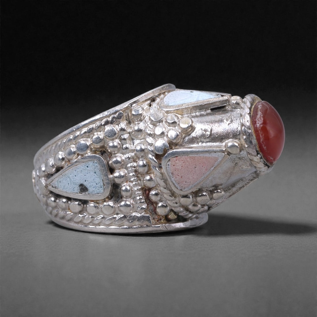 Silver Multi-Stone Ring - Domed Cabochon Design, 62X: The ring is constructed in solid silver with a wide, rounded band and a raised domed bezel. Set at the front is a polished red cabochon stone, smoothly contoured and secured within a rope-edged silver