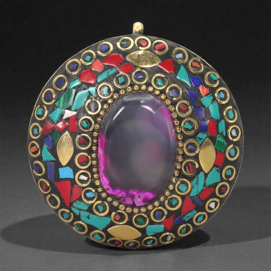 Himalayan Style Brass Pendant - Amethyst Glass Turquoise Coral Mosaic, 7XF: This circular brass pendant is organized around a large oval amethyst-colored glass cabochon set within a beaded metal border. Surrounding the central stone is a densely arranged mosaic of turquoise,