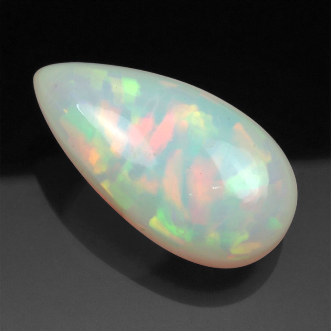 7.95 Carats Multicolor Opal Selection - Natural Welo Ethiopian Stones, 69XC: This luminous selection of Welo opals dazzles with vibrant play-of-color, ranging from electric greens and cobalt blues to sunlit oranges and flashes of violet. Each cabochon has been hand-selected fo