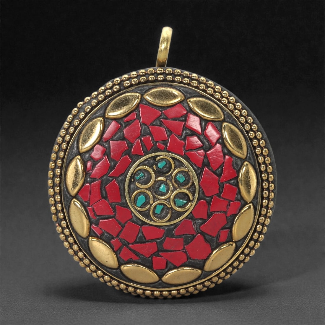 Himalayan Style Brass Pendant - Coral Turquoise Mosaic, 17XF: This circular pendant is fashioned in brass with a densely worked mosaic of red coral inlay forming the central field. At its core lies a small round medallion composed of turquoise fragments set with