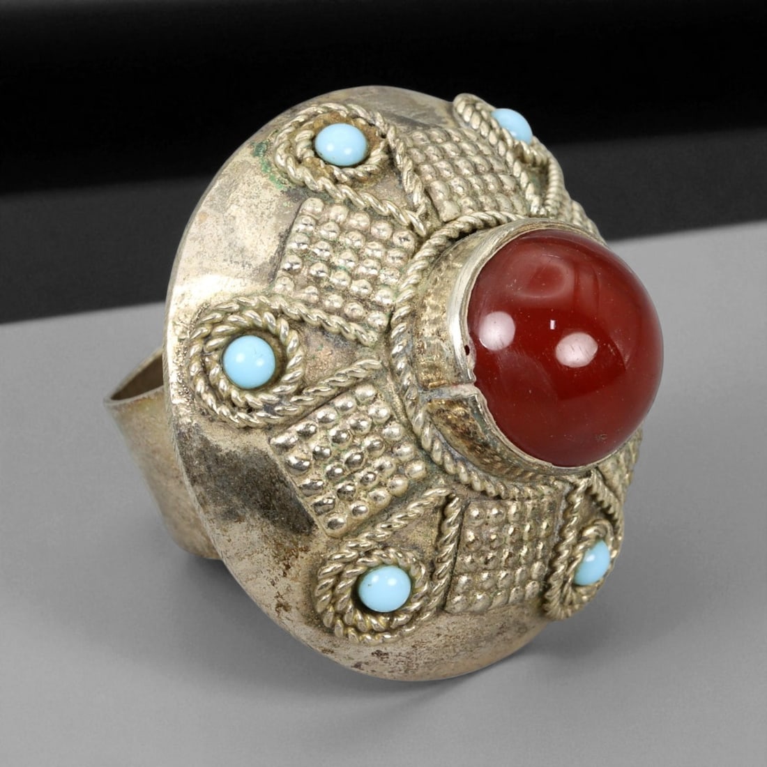 Vintage Himalayan Tribal Carnelian Turquoise Brass Ring, 20th Century, US Size 8.25, 69XD: This distinguished vintage Himalayan ring exemplifies the commanding beauty and symbolic craftsmanship of traditional tribal adornment from the high mountain regions of Nepal and Tibet. Handcrafted fr