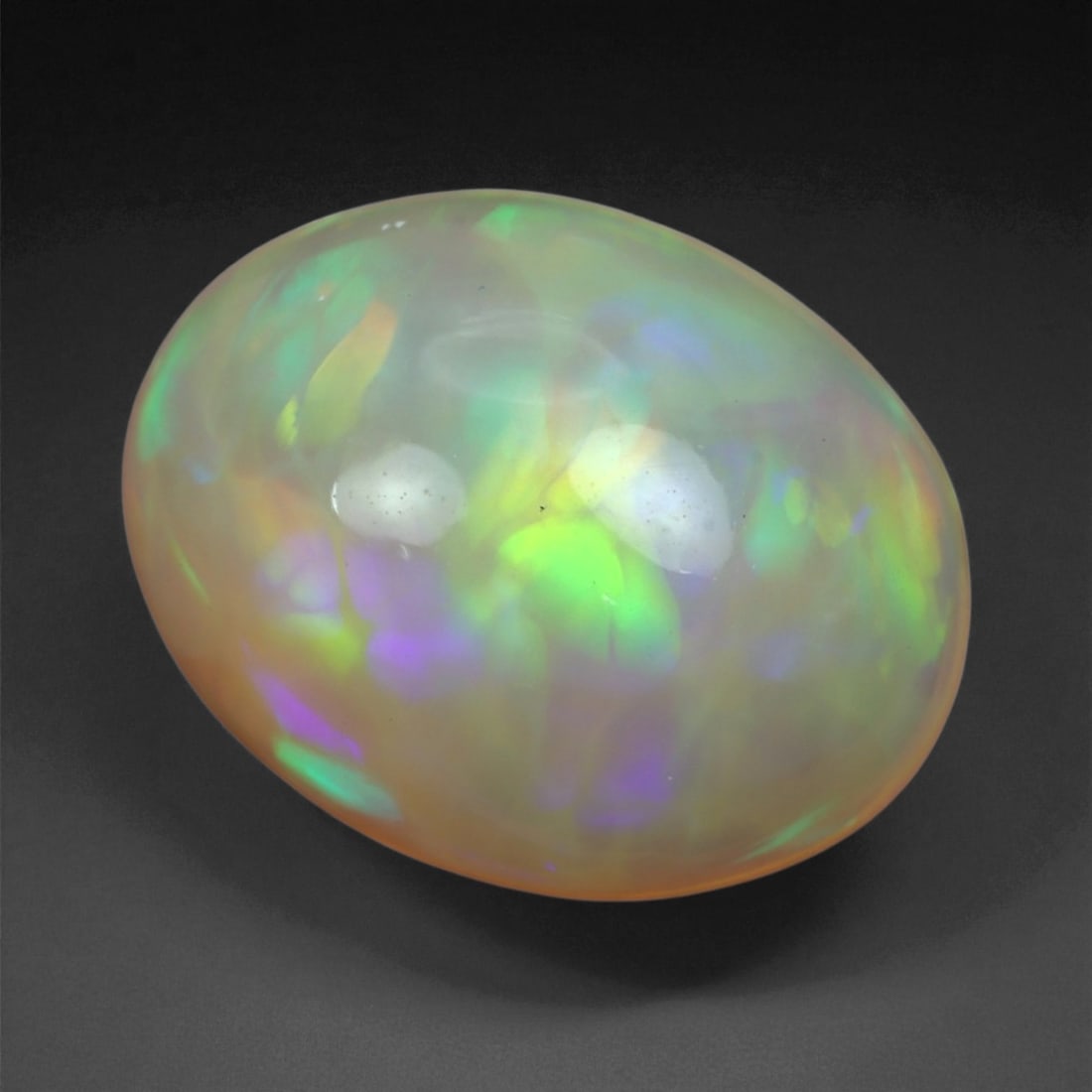 5.02 Carats Multicolor Opal Selection - Natural Welo Ethiopian Stones, 25XB: This luminous selection of Welo opals dazzles with vibrant play-of-color, ranging from electric greens and cobalt blues to sunlit oranges and flashes of violet. Each cabochon has been hand-selected fo
