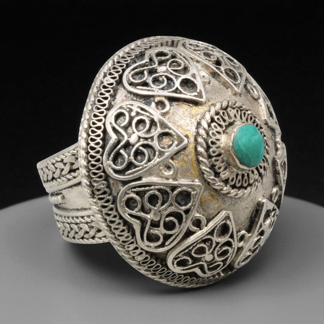 Antique Central Asian Filigree Turquoise Dome Silver Ring, c. 19th-20th Century, US 8, 36BD: This ornate antique ring exemplifies the refined filigree craftsmanship of Central Asia's silversmithing tradition, where artistry and symbolism merge in sculptural harmony. Its high domed form is cro