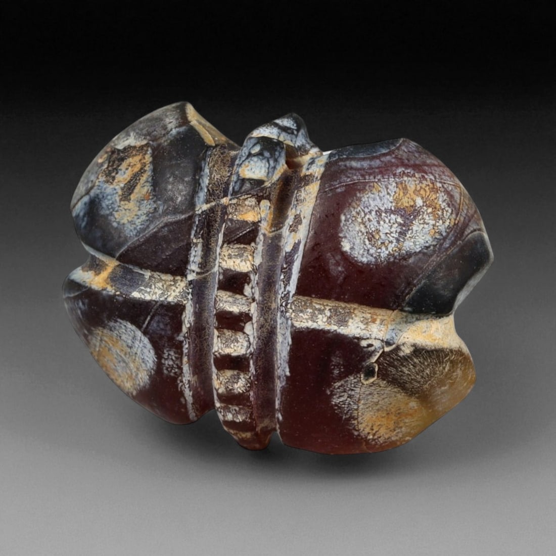 Ancient Egyptian Fly Amulet Red-Brown Carnelian, c. 1550-1070 BCE 1.8 cm (0.71 in), 2XC: This finely carved fly amulet, shaped from deep red-brown carnelian, dates to Egypt's New Kingdom period (c. 1550-1070 BCE) - a time when such symbols were bestowed as honors of bravery and worn for d