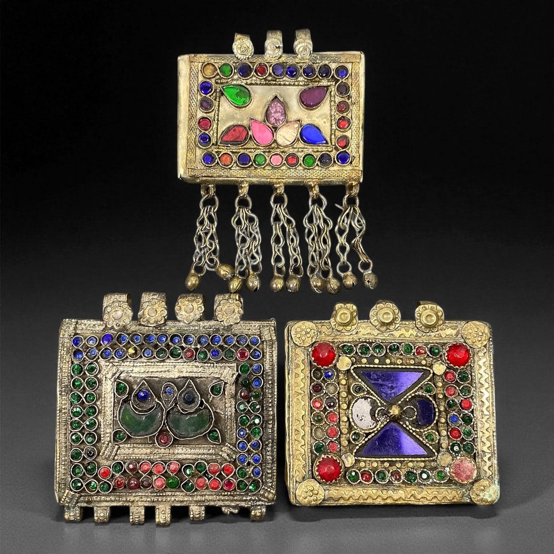 Antique Himalayan Silver Alloy Amulet Box Pendants Set, c. 19th-20th Century, 7-7.5 cm, 79EC: This captivating set of 3 antique Himalayan amulet boxes, dating to the 19th-20th century, represents the region's deep spiritual and artistic heritage. Crafted in silver alloy and richly adorned with