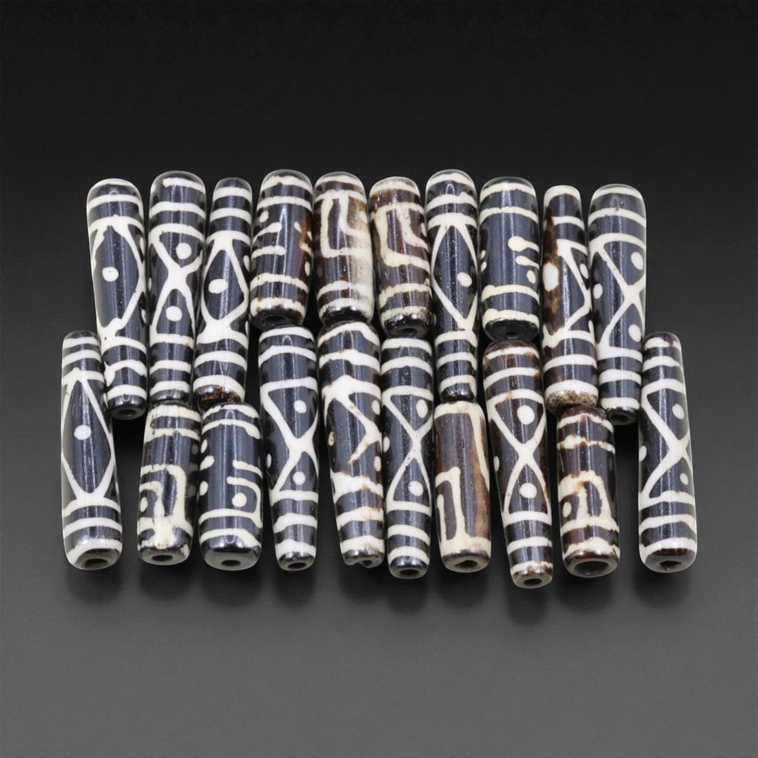 Mid-20th Century Tibetan Hand-Carved Wood Beads, 2.4-3.7cm, 9EJ: A collection of Tibetan wood beads, each individually carved and polished, showcasing the natural beauty of the dark-stained grain with contrasting pale surface decoration. These mid-century examples 