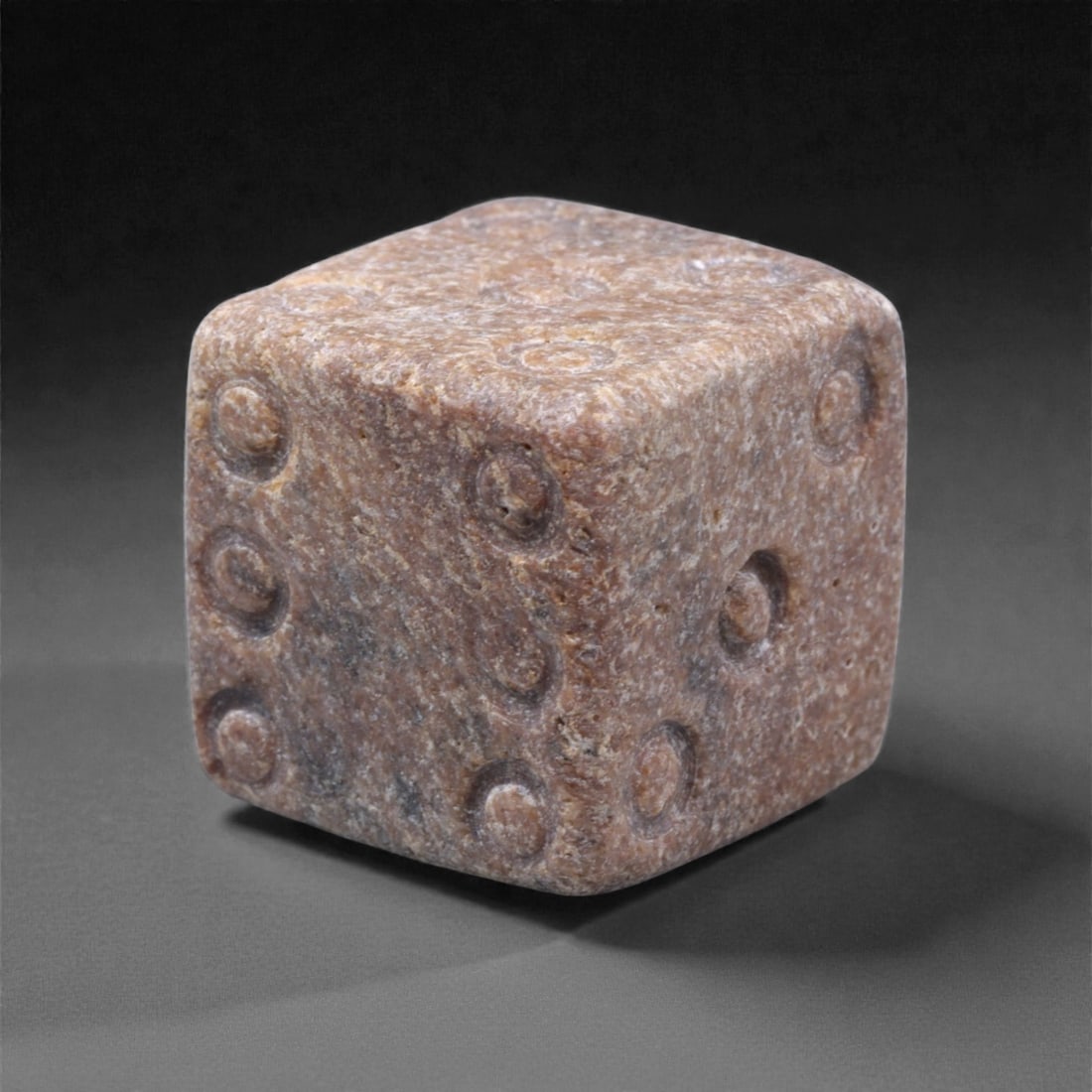 Ancient Roman Bone Gaming Die - Carved Dice, 1.4cm, 45ZD: Carved from dense animal bone, this miniature gaming die is carefully shaped into a cubic form with evenly proportioned faces and rounded edges softened through long use. The pips are drilled as shall