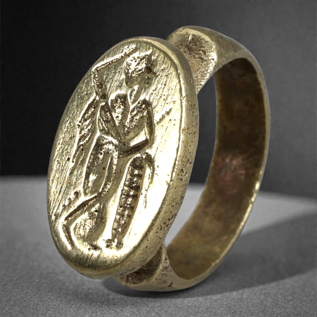Antique Qajar Era Copper Alloy Ring with Heroic Intaglio, c. 19th-20th Century, 9.7g, 44N: This antique copper alloy ring originates from the Qajar period of Persia, a dynasty celebrated for preserving Persian traditions while embracing classical imagery. The oval bezel features an engraved