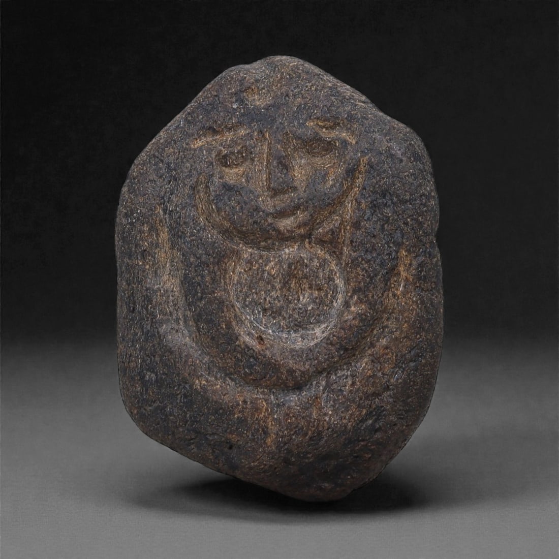 Ancient Fossilized Bone Stone Anthropomorphic Face - Near Eastern Figurine 4.3cm, 12ZD: Carved from fossilized bone stone, this small anthropomorphic face is rendered in a compact, pebble-like form with softly incised eyes, a triangular nose, and a gently curved mouth, the facial feature