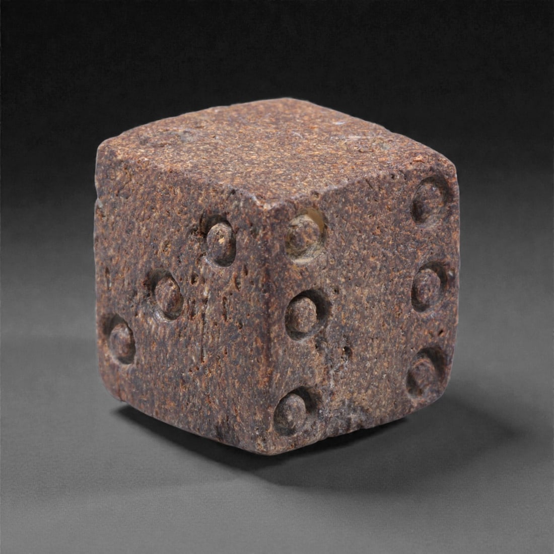 Ancient Roman Bone Gaming Die - Carved Dice, 1.5cm, 47ZD: Carved from dense animal bone, this miniature gaming die is carefully shaped into a cubic form with evenly proportioned faces and rounded edges softened through long use. The pips are drilled as shall