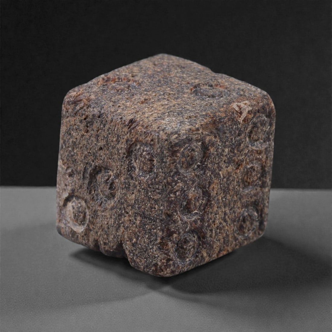 Ancient Roman Bone Gaming Die - Carved Dice, 1.3cm, 30E: Carved from dense animal bone, this miniature gaming die is carefully shaped into a cubic form with evenly proportioned faces and rounded edges softened through long use. The pips are drilled as shall