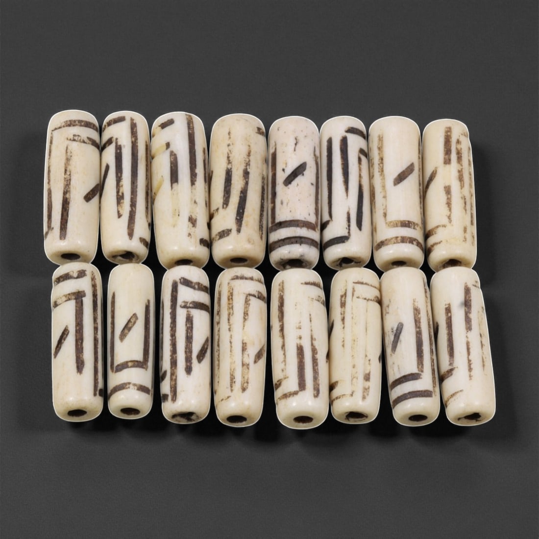Mid-20th Century Tibetan Hand-Carved Wood Beads, 2.4cm, 29EJ: A collection of Tibetan wood beads, each individually carved and polished, showcasing the natural beauty of the dark-stained grain with contrasting pale surface decoration. These mid-century examples 