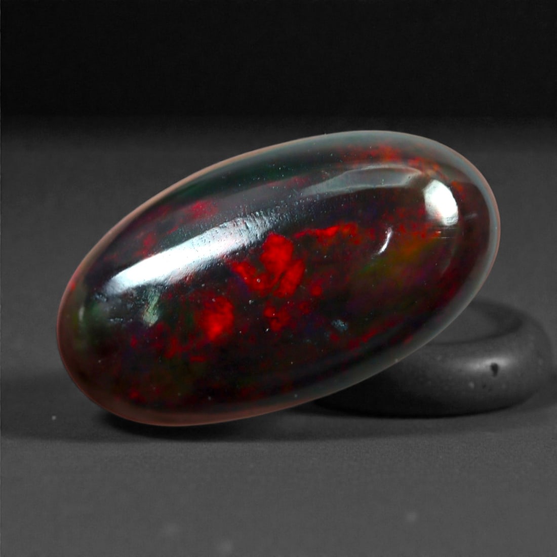 1.70 Carats Natural Welo Origin Smoked Black Opal Cabochon Gems, 13mm, 37M: This natural smoked black opal hails from the Welo region of Ethiopia, a source renowned for producing some of the world's most visually captivating opals. Through a careful and controlled smoking pro