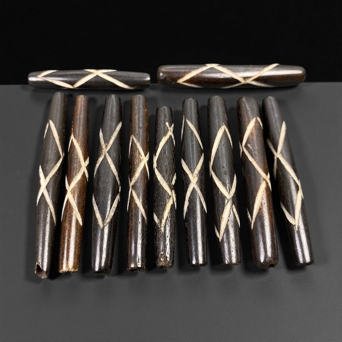 Mid-20th Century Tibetan Hand-Carved Wood Beads, 3.7-5.2cm, 96EP: A collection of Tibetan wood beads, each individually carved and polished, showcasing the natural beauty of the dark-stained grain with contrasting pale surface decoration. These mid-century examples 