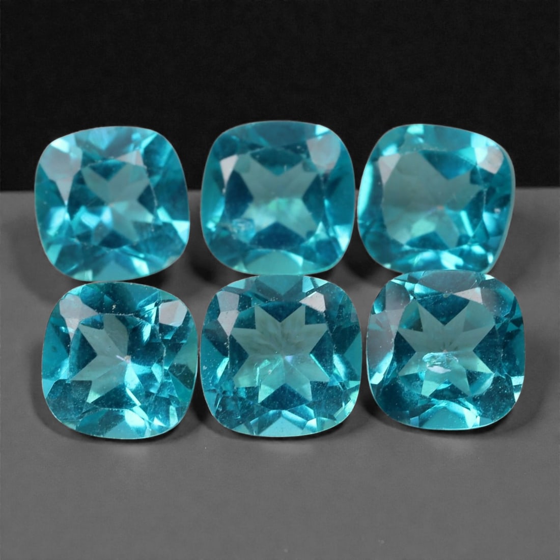 6.76 Carats Paraiba Blue Topaz Cushion Lot - Natural Brazilian Stones - 6x3mm, 72XA: This electrifying group of cushion-cut topaz gems bursts with an intense Paraiba-like blue that commands attention. The stones exhibit crisp faceting and remarkable internal brilliance, with vivid neo