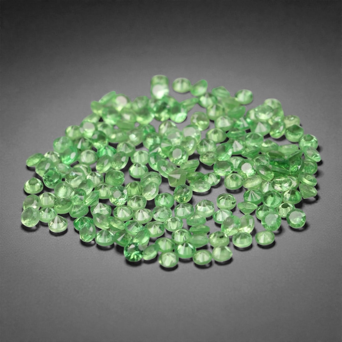 2.24 Carats Bright Green Chrome Diopside Lot - Natural Russian Stones - 1.3mm, 71XA: This dazzling micro-faceted lot of chrome diopside gems glows with a vivid grassy green hue, displaying a brilliance rarely seen in such small calibrated stones. The bright, high-saturation color pops