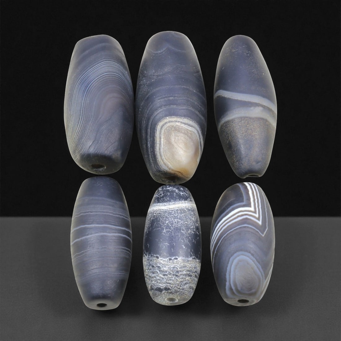 Ancient Medieval Sulaimani Agate Beads, c. 11th-14th Century CE, 3-4cm, 64EL: This elegant group of Sulaimani agate beads originates from the Indo-Persian cultural sphere of the 11th-14th centuries CE, a period when trade and craftsmanship flourished across Central and South As