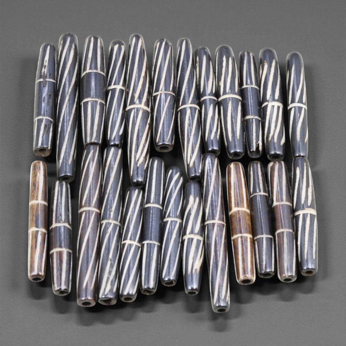 Mid-20th Century Tibetan Hand-Carved Wood Beads, 3.5-5cm, 42EJ: A collection of Tibetan wood beads, each individually carved and polished, showcasing the natural beauty of the dark-stained grain with contrasting pale surface decoration. These mid-century examples 