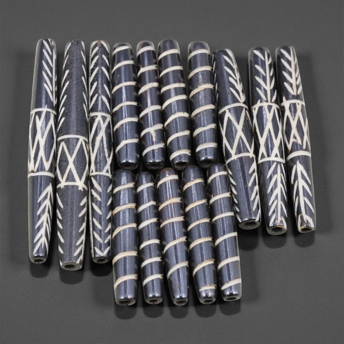 Mid-20th Century Tibetan Hand-Carved Wood Beads, 3.6-6.5cm, 49EJ: A collection of Tibetan wood beads, each individually carved and polished, showcasing the natural beauty of the dark-stained grain with contrasting pale surface decoration. These mid-century examples 