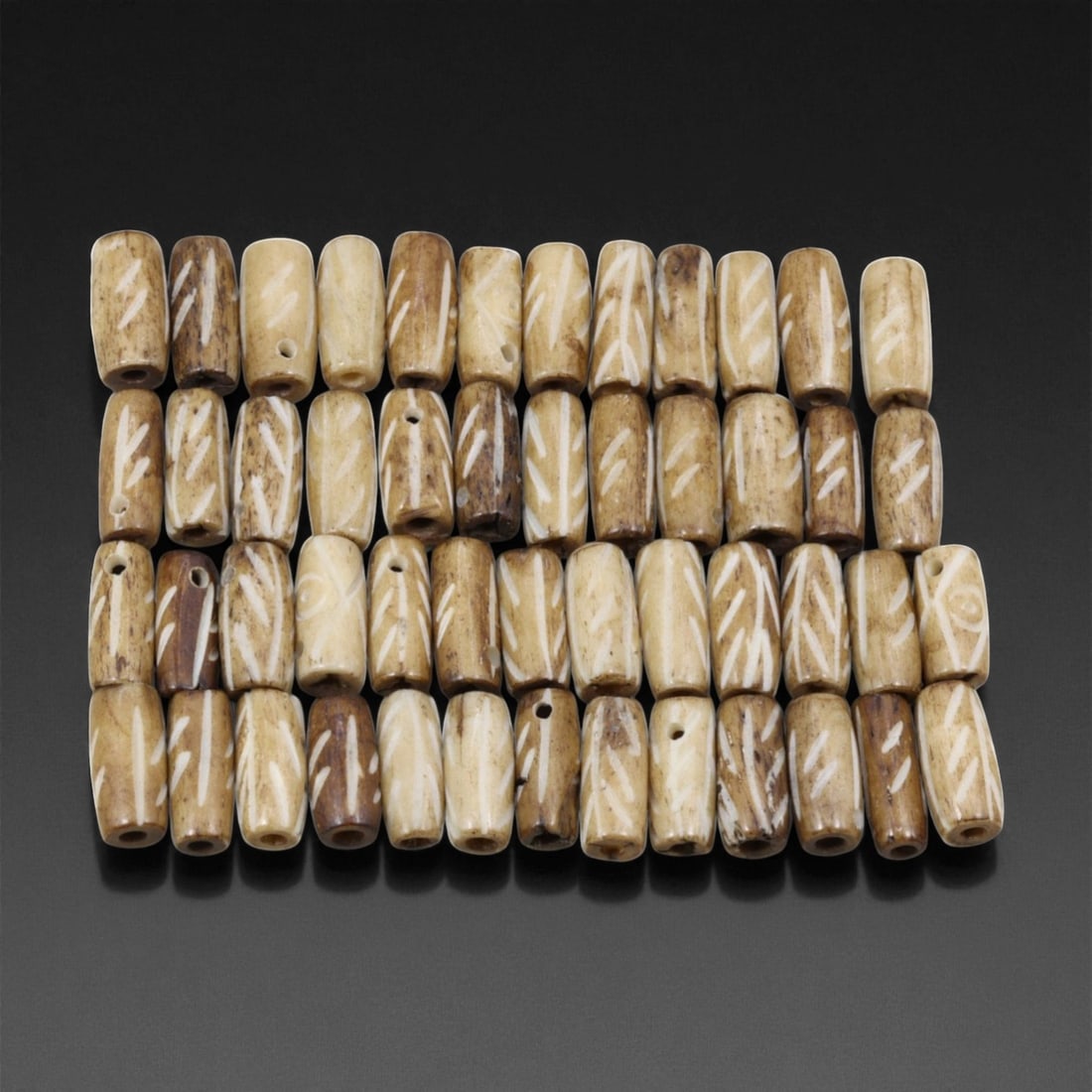 Mid-20th Century Tibetan Hand-Carved Wood Beads, 1.2cm, 14EJ: A collection of Tibetan wood beads, each individually carved and polished, showcasing the natural beauty of the dark-stained grain with contrasting pale surface decoration. These mid-century examples 