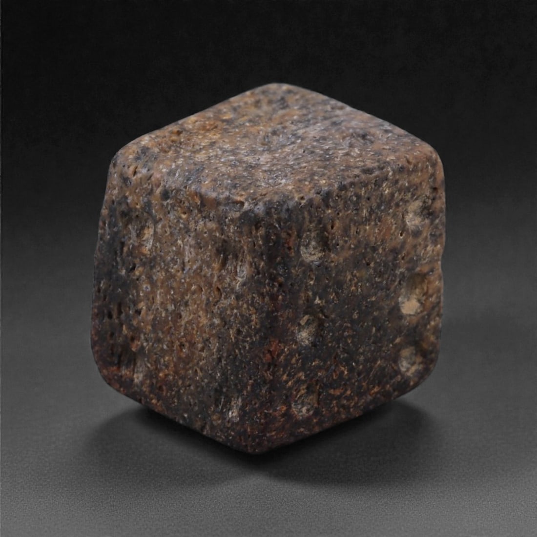 Ancient Roman Bone Gaming Die - Carved Dice, 1cm, 55E: Carved from dense animal bone, this miniature gaming die is carefully shaped into a cubic form with evenly proportioned faces and rounded edges softened through long use. The pips are drilled as shall