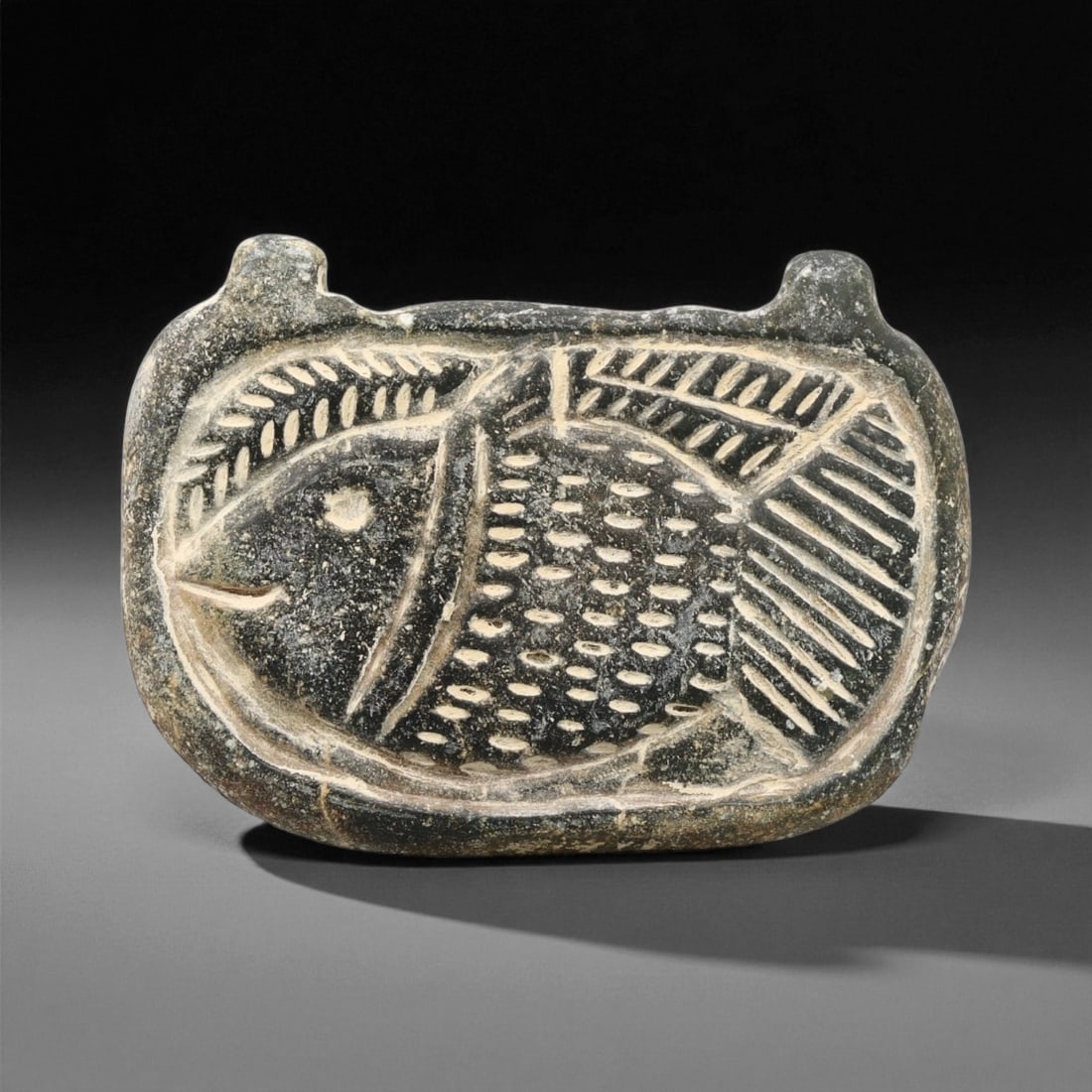 Ancient Early Dynastic Mesopotamian Fish Motif Steatite Plaque, c. 26th-23rd Century BCE, 4.6cm, 8ET: This finely carved steatite plaque originates from Early Dynastic Mesopotamia, a period when the first city-states flourished along the Tigris and Euphrates rivers. The depiction of a stylized fish wi