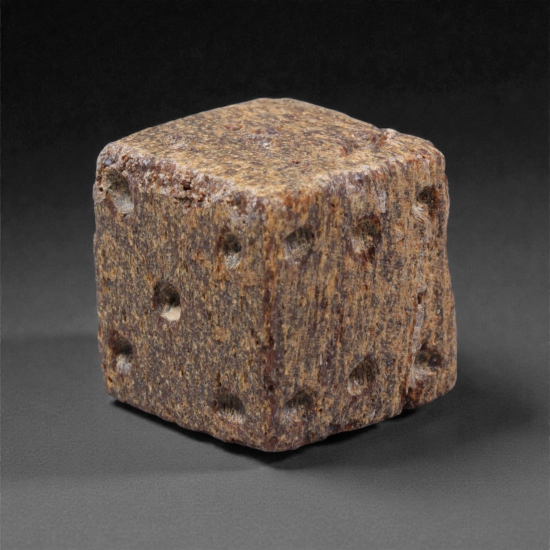 Ancient Roman Bone Gaming Die - Carved Dice, 1.3cm, 39ZD: Carved from dense animal bone, this miniature gaming die is carefully shaped into a cubic form with evenly proportioned faces and rounded edges softened through long use. The pips are drilled as shall