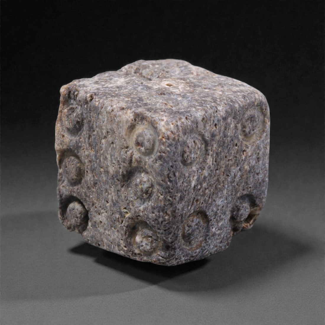 Ancient Roman Bone Gaming Die - Carved Dice, 1.2cm, 37ZD: Carved from dense animal bone, this miniature gaming die is carefully shaped into a cubic form with evenly proportioned faces and rounded edges softened through long use. The pips are drilled as shall