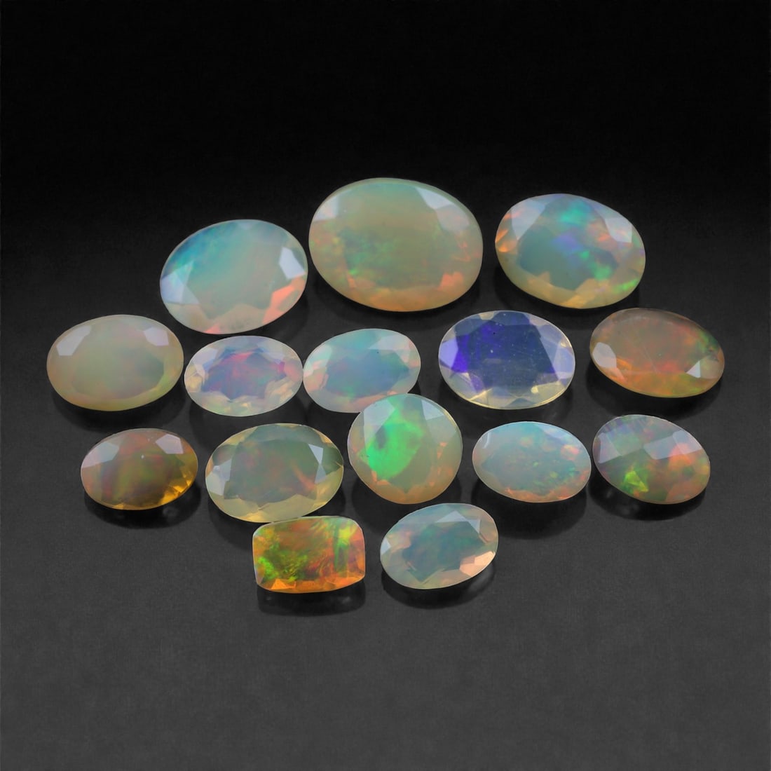 7.35 Carats Faceted Opal Lot - Natural Ethiopian Stones - 5 to 9mm, 12XA: This lively collection of faceted Ethiopian opals features a dynamic spectrum of fire, with vibrant flashes of neon green, orange, violet, and blue shimmering across their translucent to semi-crystal