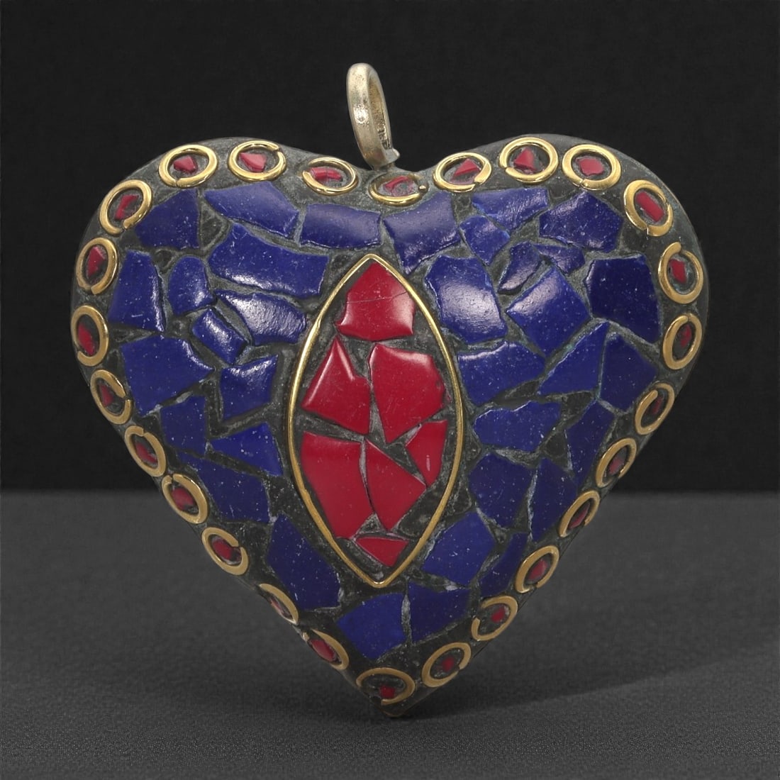 Himalayan Style Brass Pendant - Lapis Coral Mosaic Heart, 27XF: This heart-shaped brass pendant is composed of deep blue lapis mosaic fragments set within a darkened ground that heightens their tonal richness. At the center sits a vertically aligned marquise-shape
