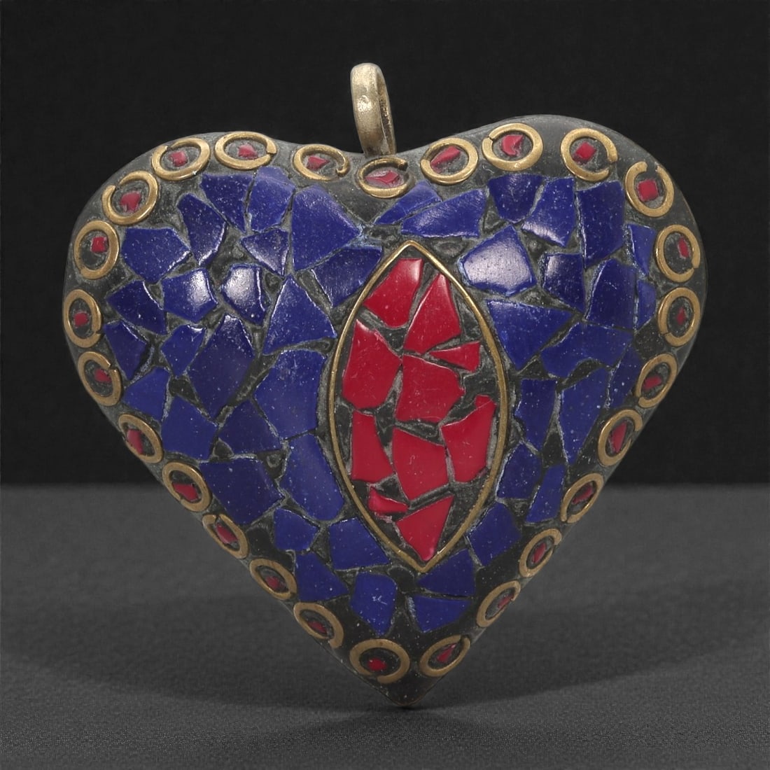 Himalayan Style Brass Pendant - Lapis Coral Mosaic Heart, 39XF: Shaped as a symmetrical heart, this brass pendant is densely inlaid with deep blue lapis mosaic pieces set into a darkened ground. At the center, a marquise-shaped field of red coral mosaic introduces