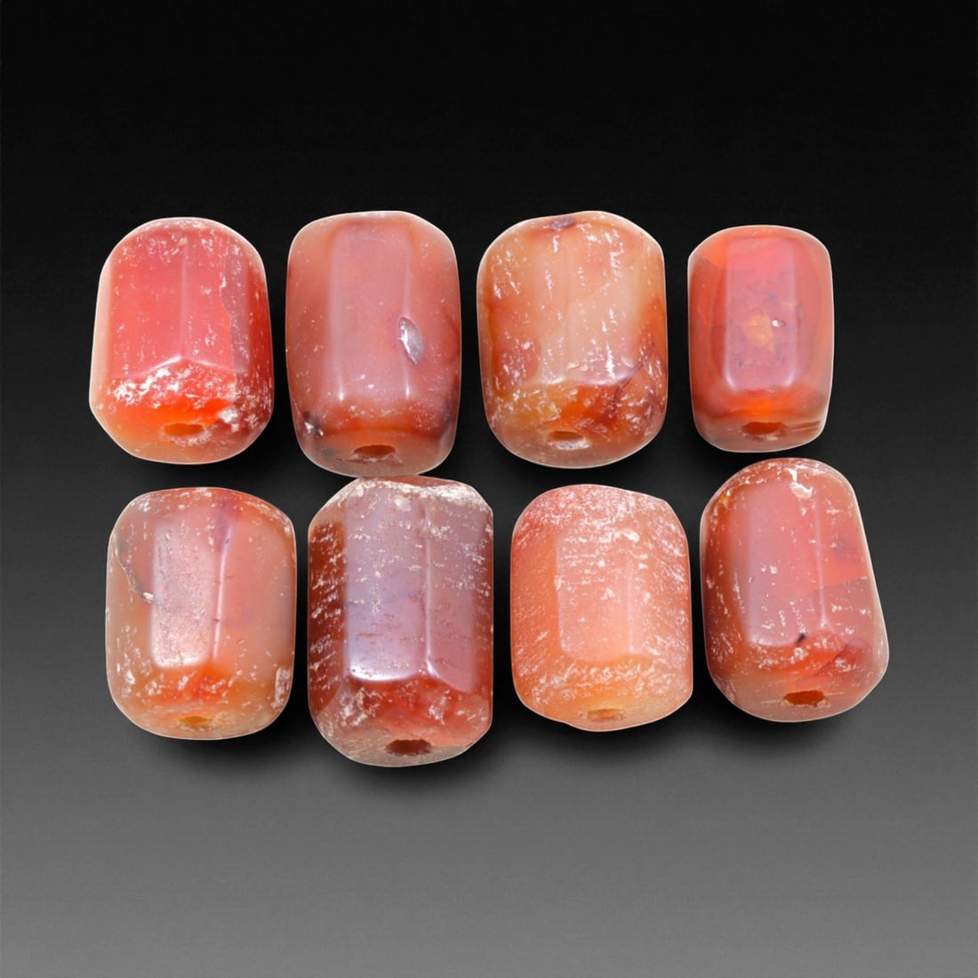 Ancient Medieval Indian Carnelian Barrel Beads, c. 10th-13th Century CE, 1.5-1.9cm, 9EL: These luminous barrel-shaped beads were crafted from carnelian during the medieval period of the Indian subcontinent, between the 10th and 13th centuries CE. Their warm red-orange translucency and sub