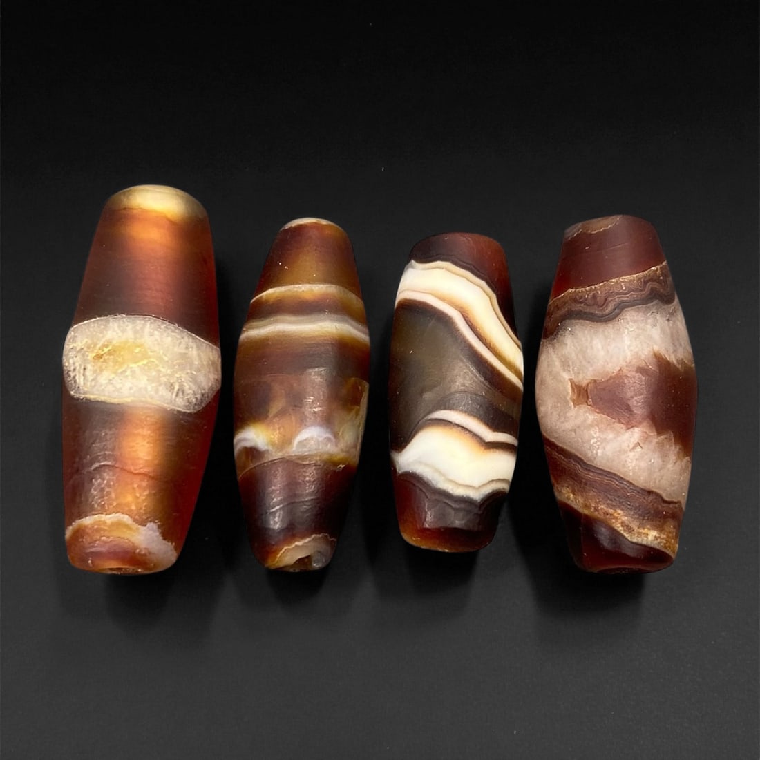 Ancient Persian Banded Agate Barrel Beads, c. 5th-3rd Century BCE, 2.2-2.6cm, 54EF: These elegant ancient Persian agate beads date to the Achaemenid to early Parthian period, circa 5th-3rd century BCE. Expertly shaped into elongated barrel forms, each bead displays the natural bandin