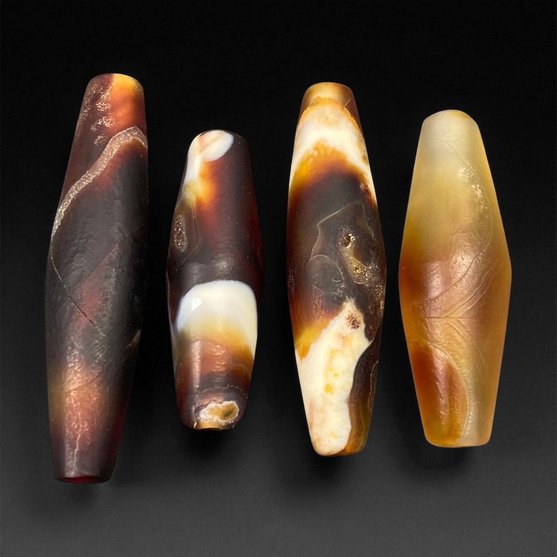 Ancient Persian Banded Agate Barrel Beads, c. 5th-3rd Century BCE, 3.1-4.2cm, 66EF: These elegant ancient Persian agate beads date to the Achaemenid to early Parthian period, circa 5th-3rd century BCE. Expertly shaped into elongated barrel forms, each bead displays the natural bandin