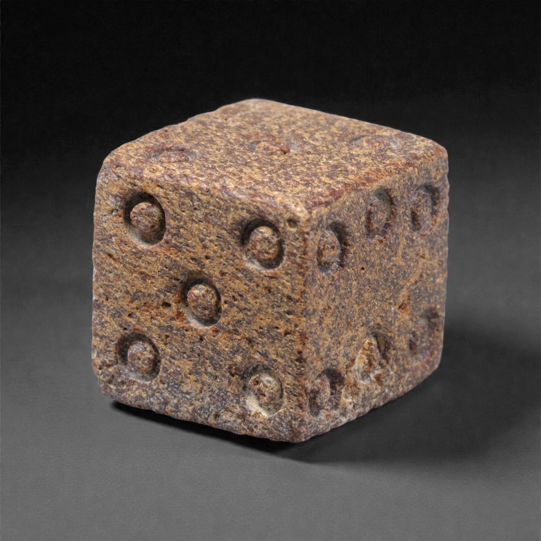 Ancient Roman Bone Gaming Die - Carved Dice, 1.5cm, 48ZD: Carved from dense animal bone, this miniature gaming die is carefully shaped into a cubic form with evenly proportioned faces and rounded edges softened through long use. The pips are drilled as shall