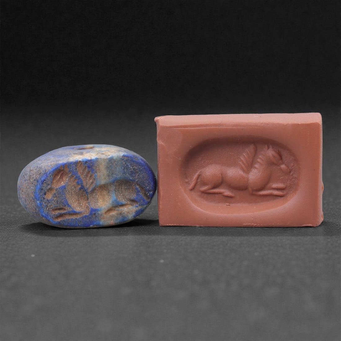 A Near Eastern Lapis Lazuli Hemispherical Stamp Seal, 3rd Millennium BCE, 2.1cm, 13N: Carved from lapis lazuli with mottled blue coloration and lighter mineral inclusions, the seal is hemispherical in form with a flat engraved base and a gently domed upper surface. A small perforation 