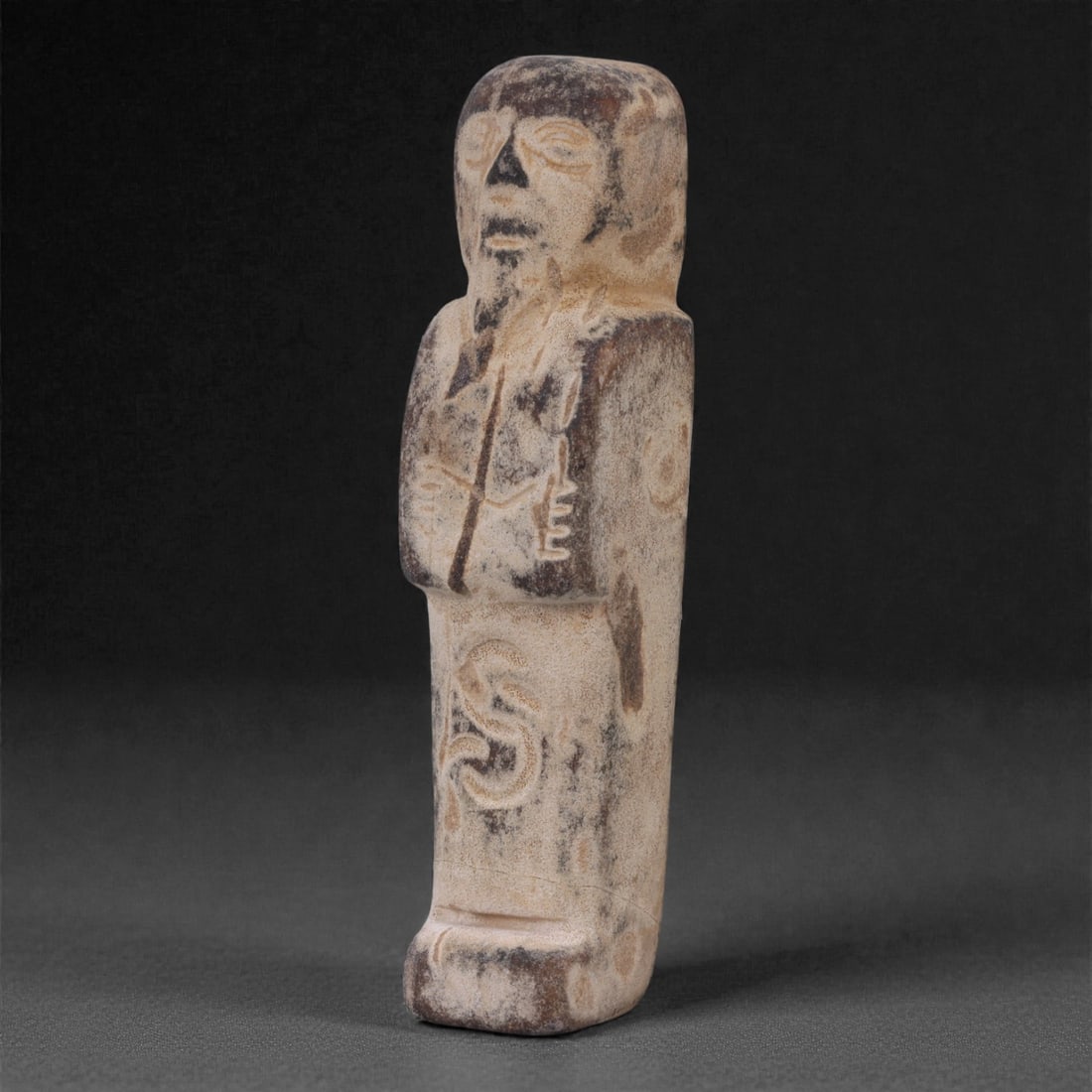 Egyptian Revival Stone Idol - Mummiform Figure, 70F: Carved from a pale, fine-grained stone, this mummiform figure is rendered in a compact frontal form with a rounded head, softly modeled facial features, and schematically indicated arms folded against