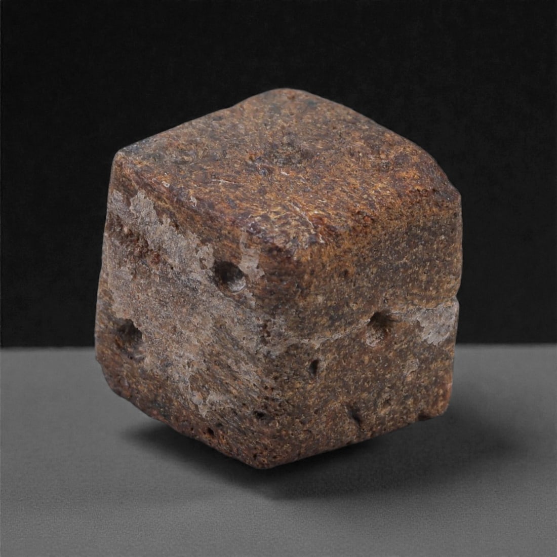 Ancient Roman Bone Gaming Die - Carved Dice, 1.3cm, 48E: Carved from dense animal bone, this miniature gaming die is carefully shaped into a cubic form with evenly proportioned faces and rounded edges softened through long use. The pips are drilled as shall