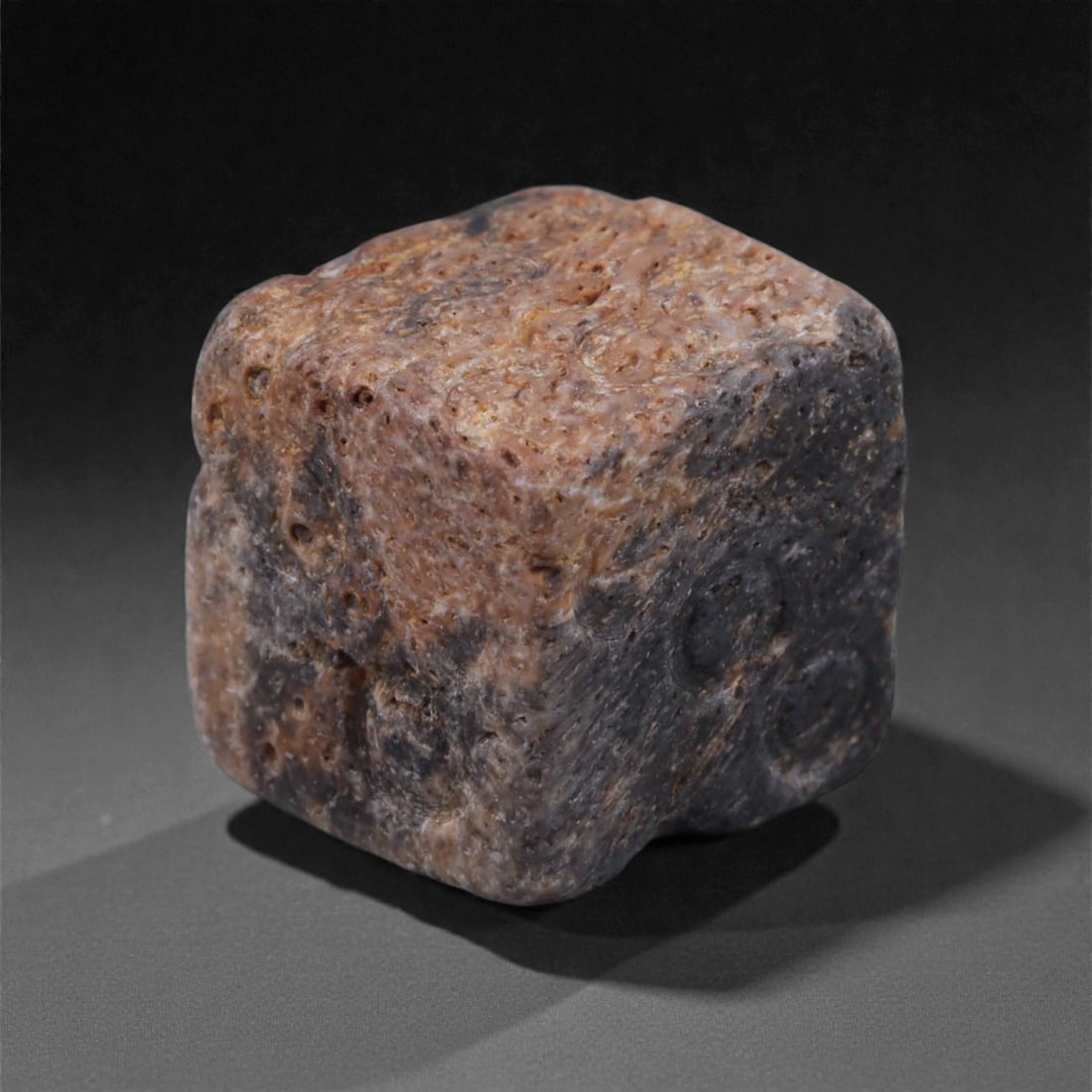 Ancient Roman Bone Gaming Die - Carved Dice, 1.1cm, 71E: Carved from dense animal bone, this miniature gaming die is carefully shaped into a cubic form with evenly proportioned faces and rounded edges softened through long use. The pips are drilled as shall