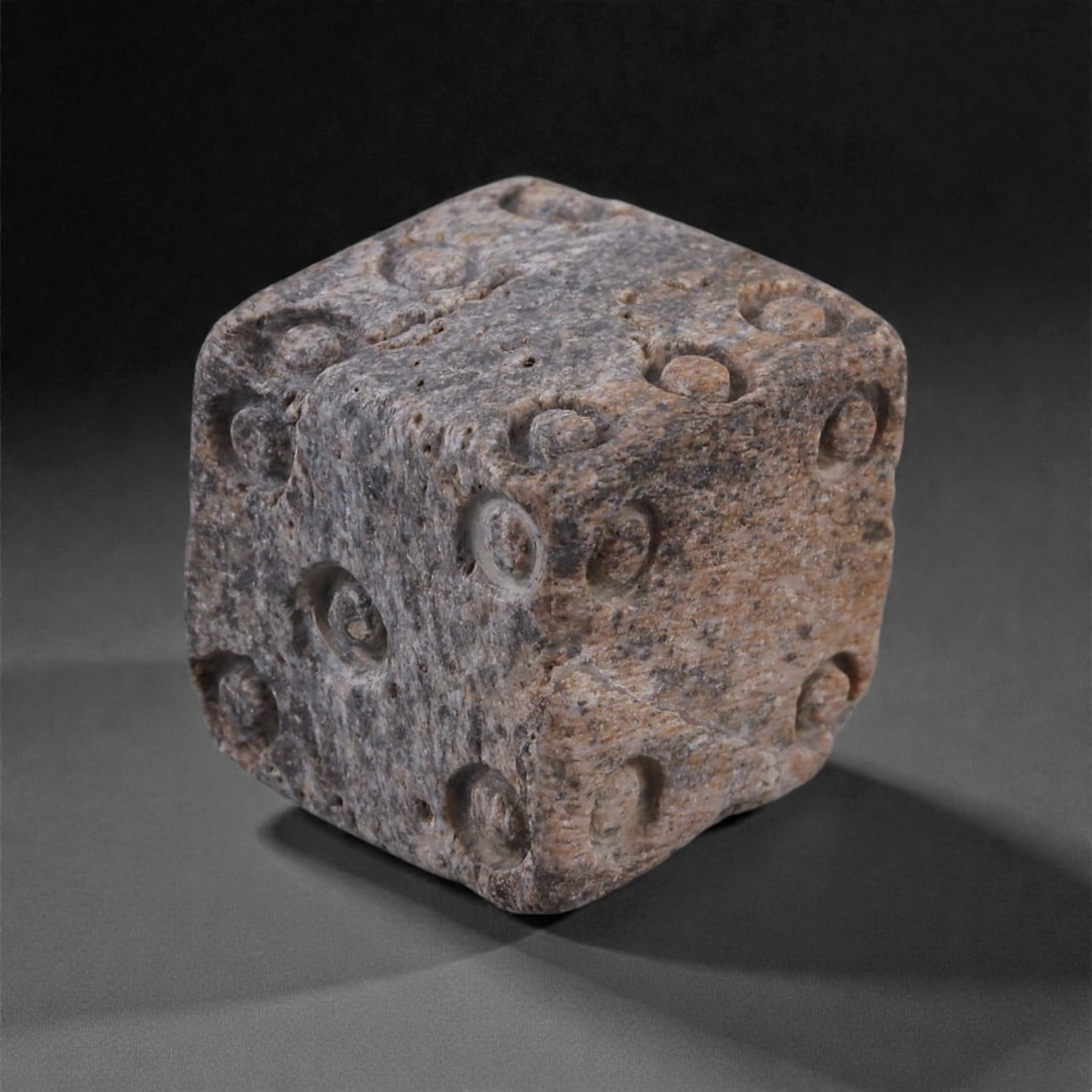 Ancient Roman Bone Gaming Die - Carved Dice, 1.5cm, 40E: Carved from dense animal bone, this miniature gaming die is carefully shaped into a cubic form with evenly proportioned faces and rounded edges softened through long use. The pips are drilled as shall