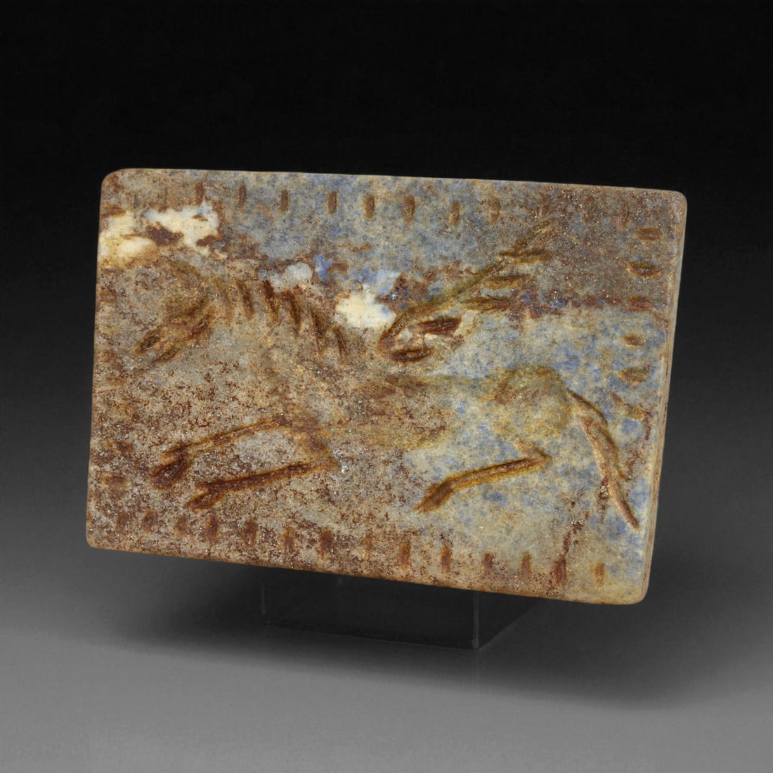 Ancient Neo-Babylonian Lapis Lazuli Flying Horse Plaque Amulet, c. 7th-6th Century BCE 33g, 40BG: This exceptional lapis lazuli amulet, dating to the Neo-Babylonian Empire, captures a rare and evocative image of a flying horse carved in low relief. Measuring 6 cm and weighing 33 g, it is a substan