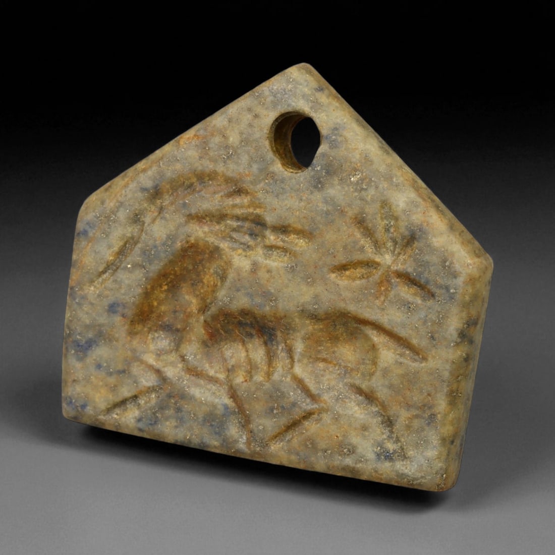 Ancient Neo-Babylonian Lapis Lazuli Ibex Motif Amulet, c. 7th-6th Century BCE 13g, 66BG: This striking amulet, carved from deep blue lapis lazuli, originates from the Neo-Babylonian Empire, a period renowned for its wealth, craftsmanship, and devotion to protective symbolism. Dating to th
