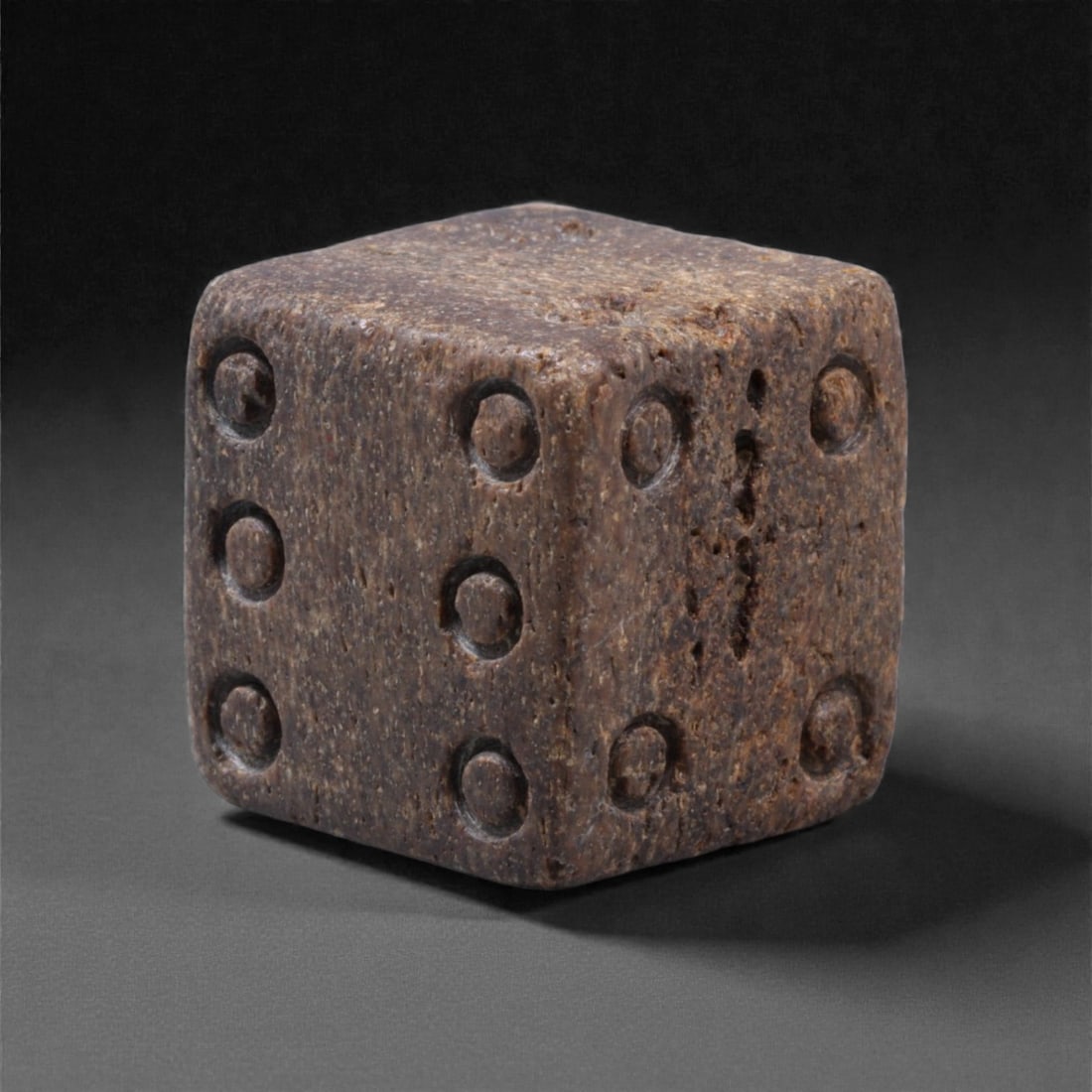 Ancient Roman Bone Gaming Die - Carved Dice, 2F: Carved from dense animal bone, this miniature gaming die is carefully shaped into a cubic form with evenly proportioned faces and rounded edges softened through long use. The pips are drilled as shall