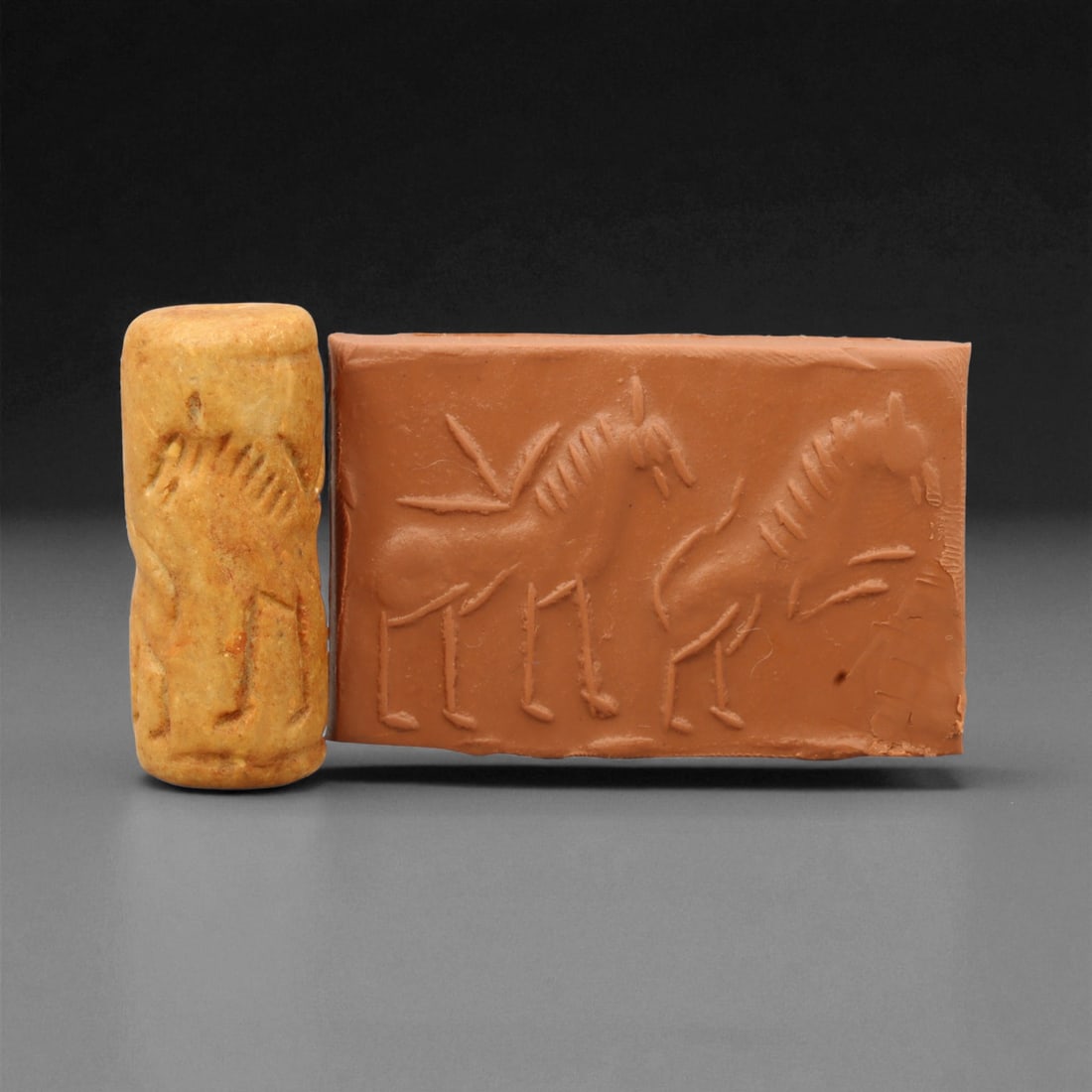 A Mesopotamian Stone Cylinder Seal, 3rd-2nd Millennium BCE, 4cm, 95M: This Mesopotamian cylinder seal dates to the 2nd-1st millennium BCE. Carved from stone, it would have been used to roll designs onto wet clay as a mark of ownership or identification. The seal fits co