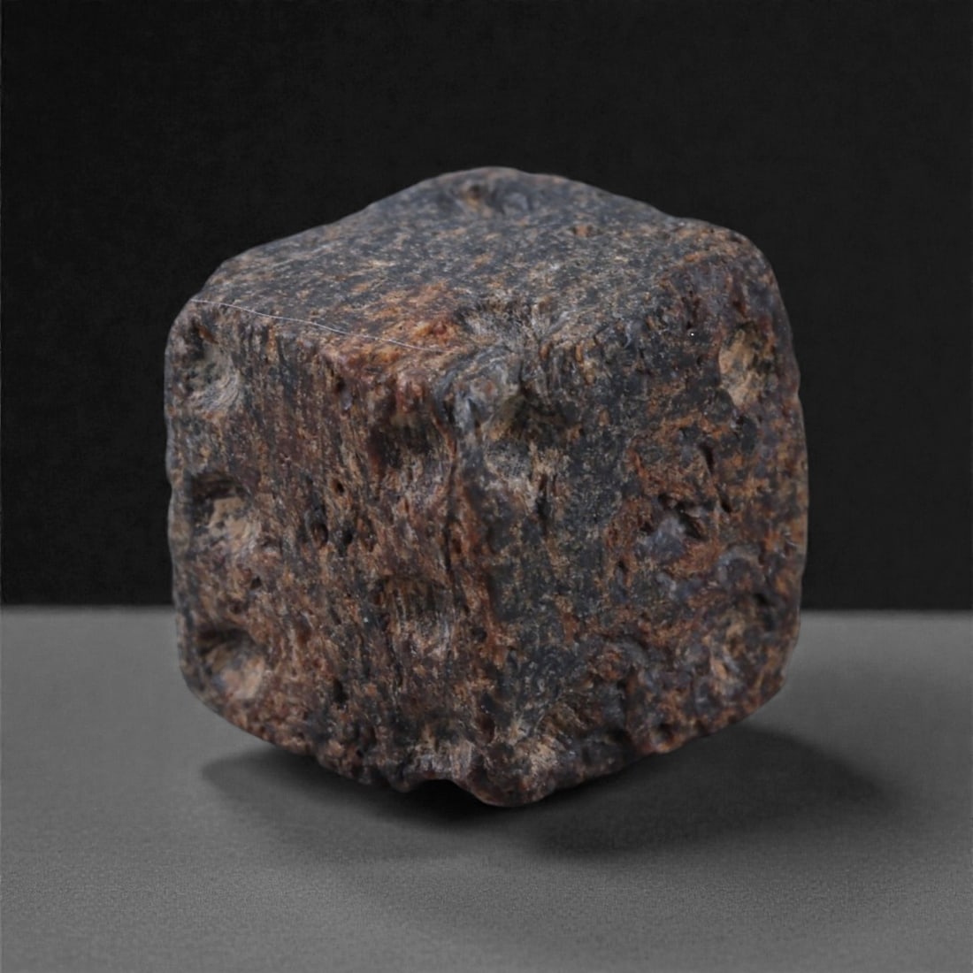 Ancient Roman Bone Gaming Die - Carved Dice, 0.9cm, 52E: Carved from dense animal bone, this miniature gaming die is carefully shaped into a cubic form with evenly proportioned faces and rounded edges softened through long use. The pips are drilled as shall
