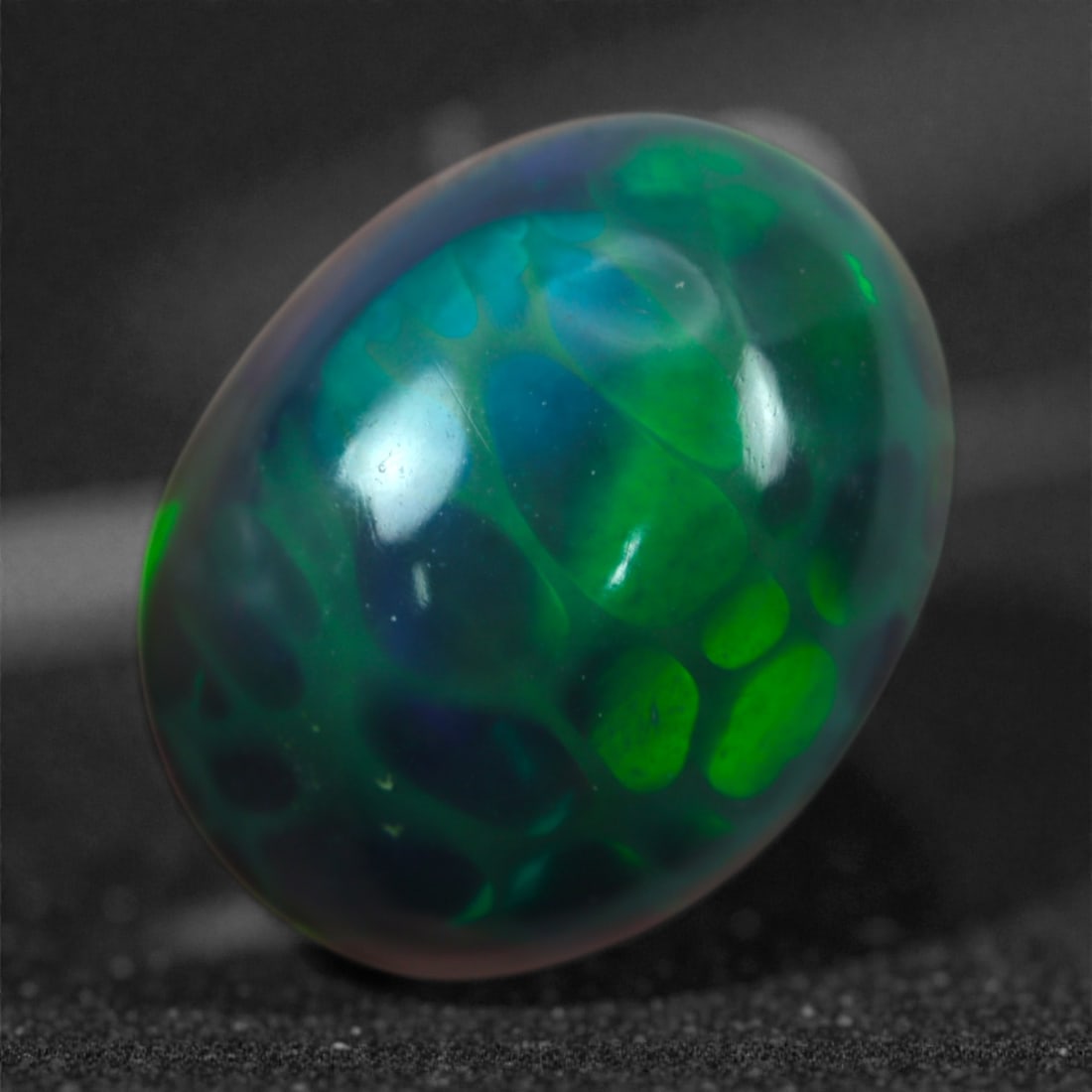 2.30 Carats Natural Welo Origin Smoked Black Opal Cabochon Gems, 11mm, 88M: This natural smoked black opal hails from the Welo region of Ethiopia, a source renowned for producing some of the world's most visually captivating opals. Through a careful and controlled smoking pro