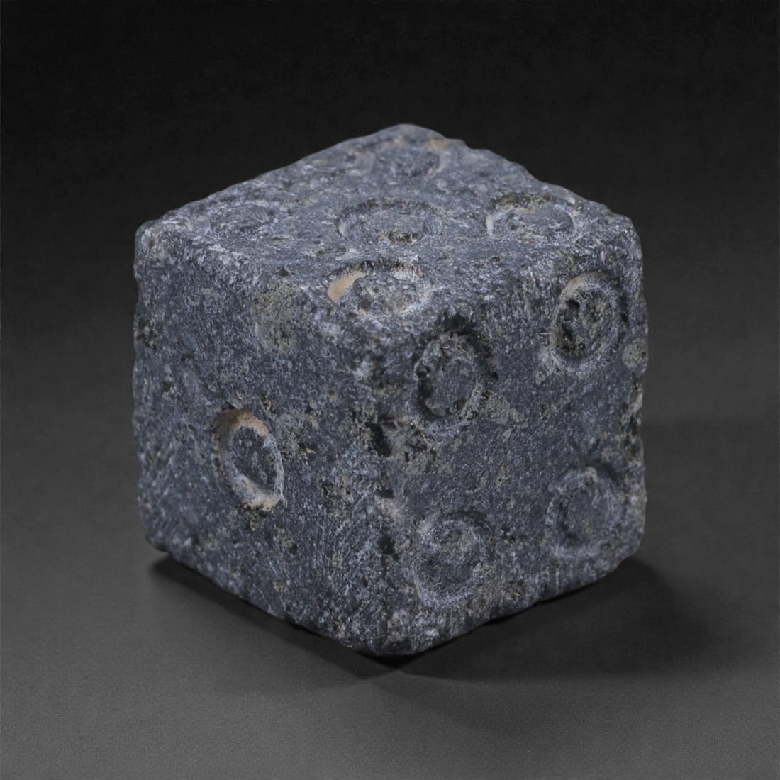 Ancient Roman Bone Gaming Die - Carved Dice, 1.1cm, 81E: Carved from dense animal bone, this miniature gaming die is carefully shaped into a cubic form with evenly proportioned faces and rounded edges softened through long use. The pips are drilled as shall
