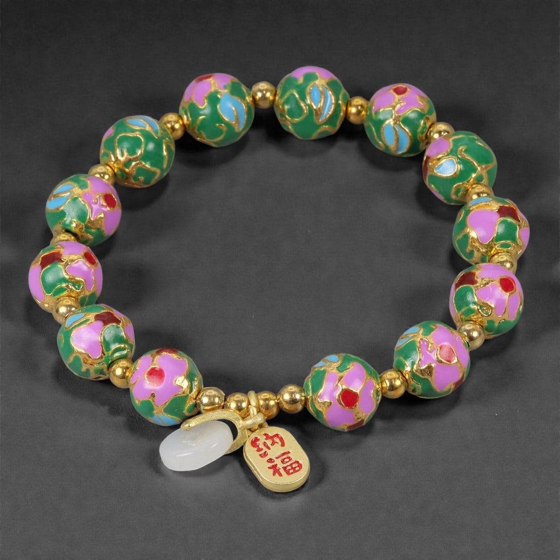 A Chinese Cloisonne Enamel Bracelet, 20th-21st Century, 89YB: Formed as a circular bracelet composed of spherical cloisonne enamel beads alternating with small gilt metal spacers. The beads are decorated with opaque green enamel grounds, articulated with fine gi